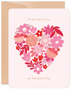 Front of a romantic floral greeting card for Valentine's Day, featuring a heart shape intricately formed by various pink, red, and white flowers on a soft pink background, with the text 'To the One I Love' and 'on Valentine's Day' in elegant script. A kraft paper envelope is visible behind it.