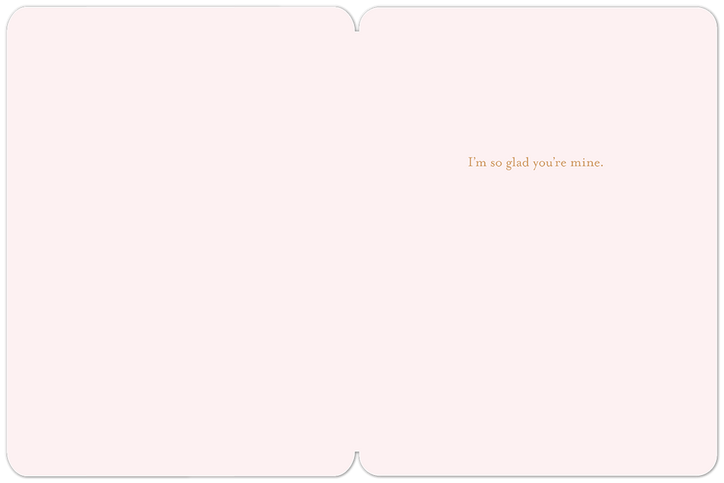 Inside of a romantic greeting card, light pink with the sweet message 'I'm so glad you're mine' in brown script on the right side, ideal for a loved one.