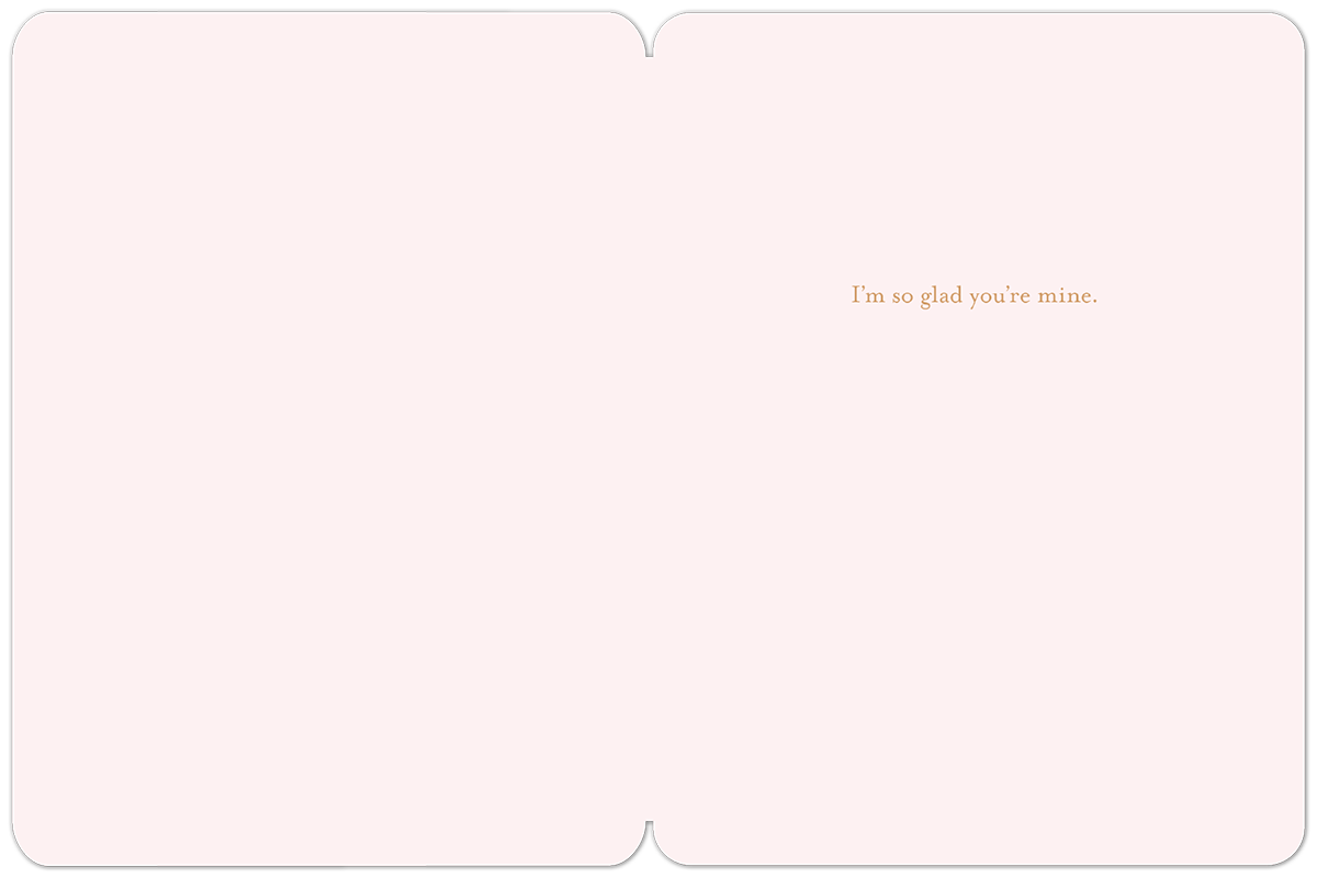 Inside of a romantic greeting card, light pink with the sweet message 'I'm so glad you're mine' in brown script on the right side, ideal for a loved one.