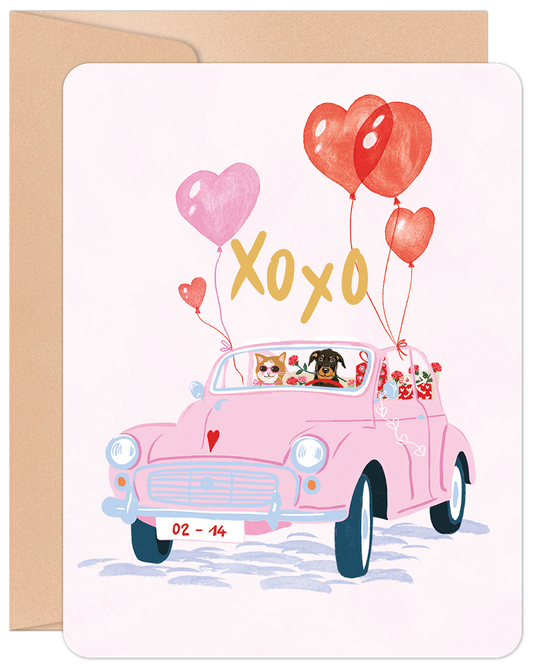 Front of Valentine's Day card showing a pink vintage car with a cat and dog, heart balloons, and XOXO.