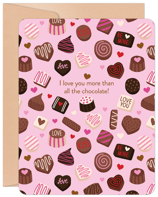 Front of a pink Valentine's Day card covered in chocolate and heart patterns, with the text "I love you more than all the chocolate!".