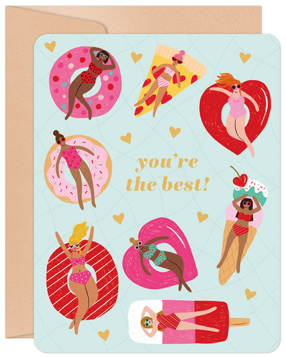 Front of a Galentine's Day greeting card featuring a fun illustration of diverse women in swimsuits floating on colorful pool inflatables, with text "you're the best!".