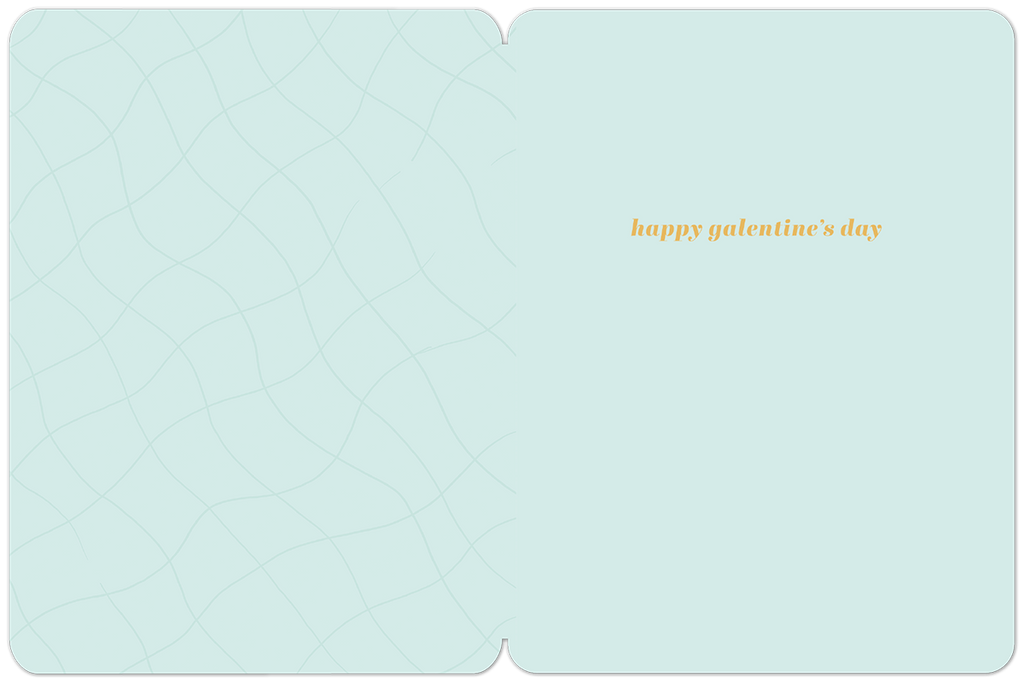 Inside of a light blue Galentine's Day greeting card with a subtle wavy pattern, featuring the orange text 'happy galentine's day'.