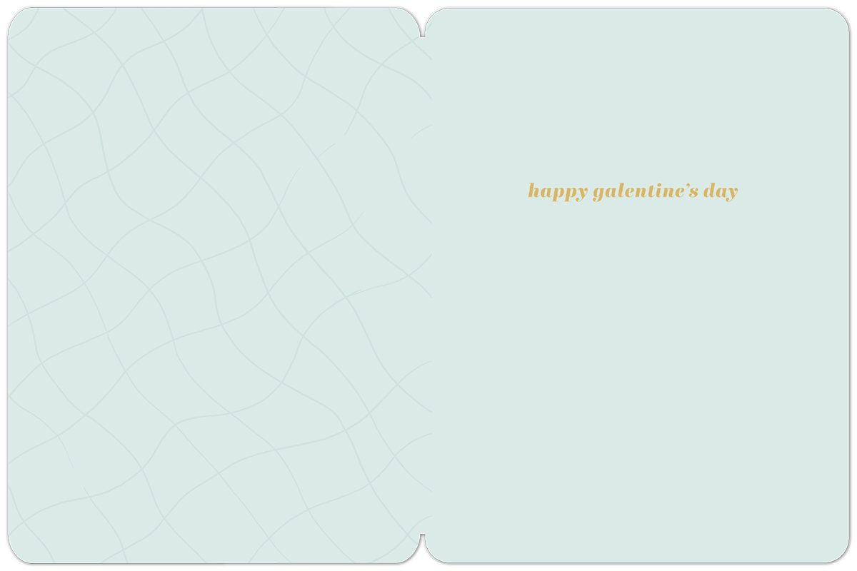 Inside of a light blue Galentine's Day greeting card with a subtle wavy pattern, featuring the orange text 'happy galentine's day'.