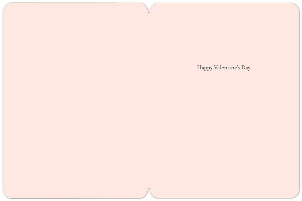 Inside view of an elegant greeting card, showing a blank light pink interior with a subtle border and 'Happy Valentine's Day' printed on the right side.