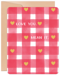 Front view of a Valentine's Day greeting card featuring a charming red and white gingham pattern adorned with golden hearts. The card displays the heartfelt message 'LOVE YOU. MEAN IT.' in white text, perfect for expressing affection.