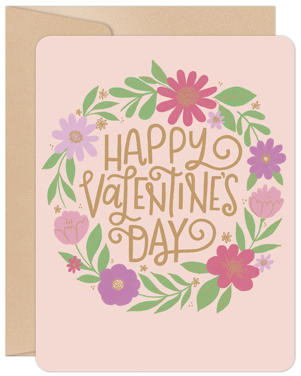 Front of a cheerful pink greeting card with a vibrant floral wreath design in pink, purple, and green, surrounding the gold text 'Happy Valentine's Day'. Perfect for a cute message.