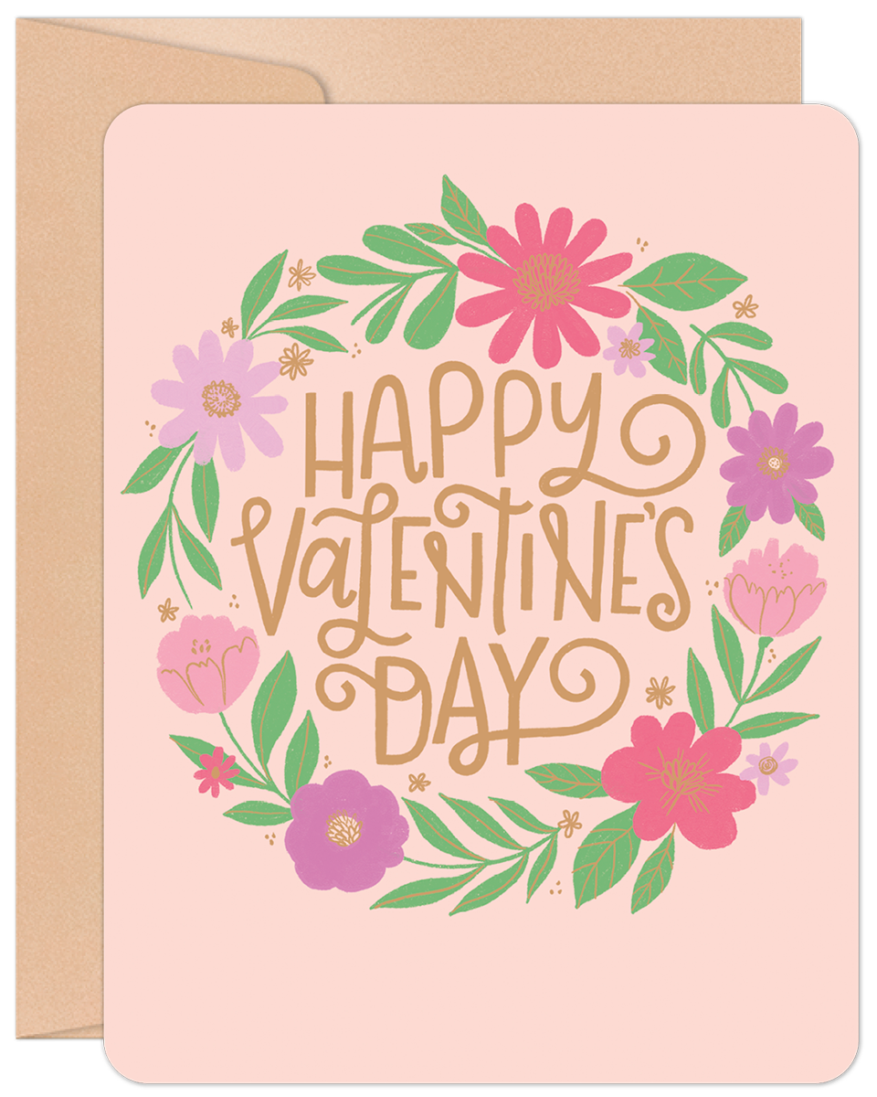 Happy Valentine's Day floral wreath greeting card with pink, purple, and green flowers on a light pink background, includes an envelope.