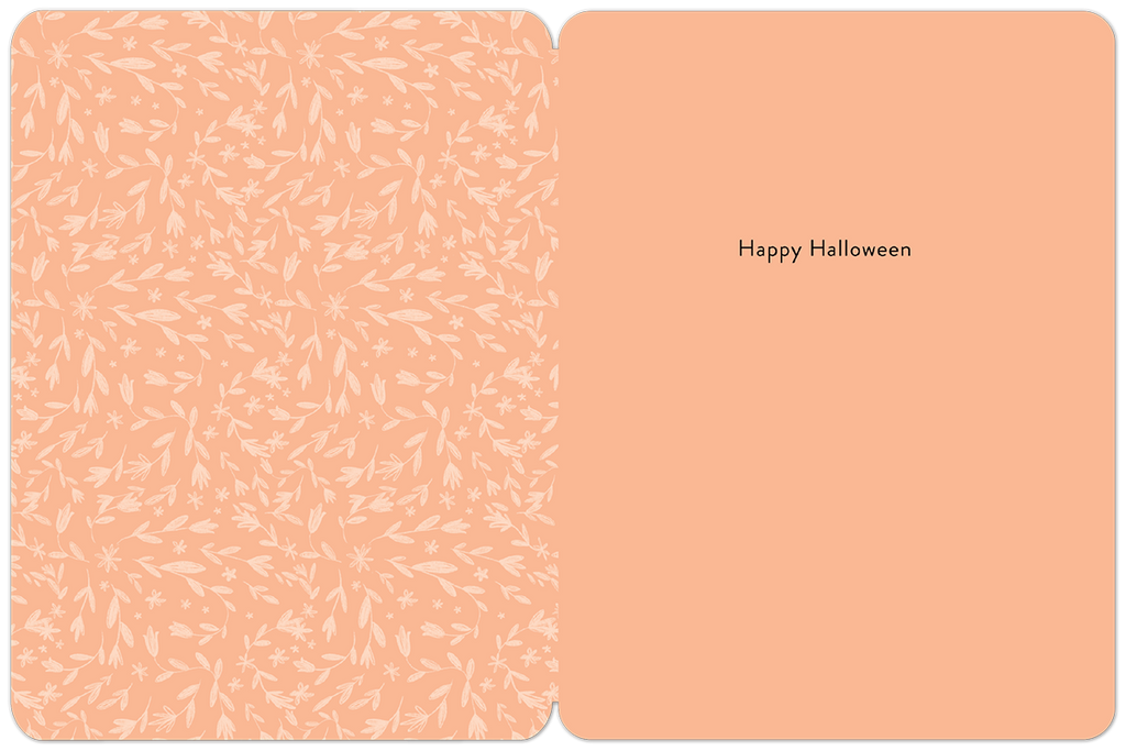 Inside view of a cheerful peach-colored Halloween greeting card. The left panel showcases a delicate white floral and leaf pattern, while the right panel displays 'Happy Halloween' in elegant black script. Perfect for personalized seasonal messages.