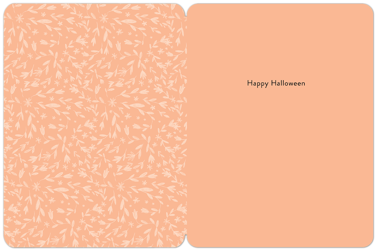 Inside view of a cheerful peach-colored Halloween greeting card. The left panel showcases a delicate white floral and leaf pattern, while the right panel displays 'Happy Halloween' in elegant black script. Perfect for personalized seasonal messages.