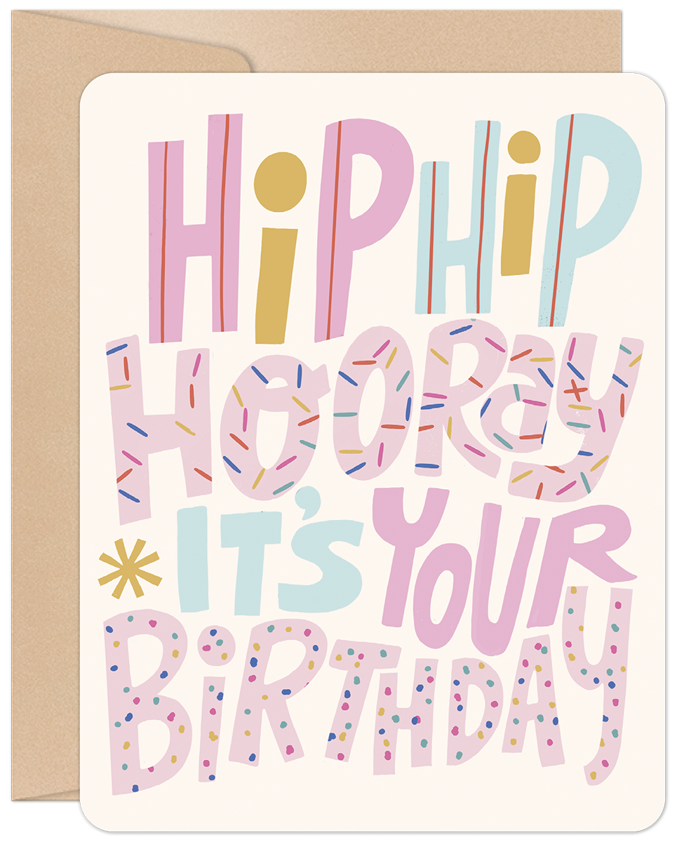 Vibrant birthday greeting card featuring 'Hip Hip Hooray It's Your Birthday' in colorful, sprinkle-adorned block letters, with a brown envelope.