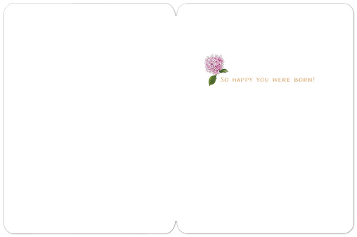 Inside of a minimalist white birthday greeting card showing a single pink hydrangea illustration and the golden script 'So happy you were born!', offering ample space for a personalized message.