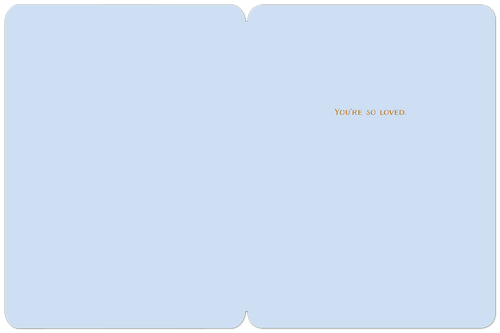 Open birthday greeting card revealing a serene light blue interior with a subtle texture, displaying the heartfelt message 'You're so loved' in coordinating gold lettering on the right panel.