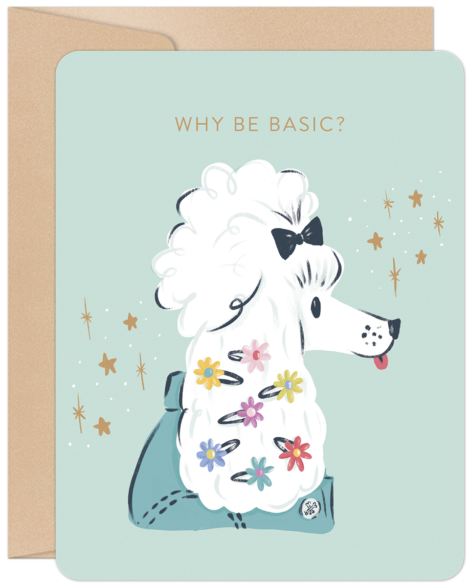 Front of a light blue greeting card featuring a stylish white poodle with colorful flower clips and a black bow. Text reads "WHY BE BASIC?" with sparkling stars around the dog. A kraft envelope is visible on the left.