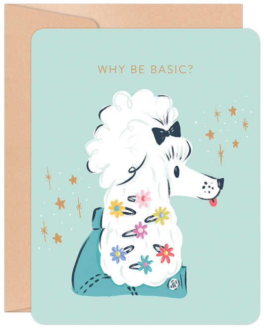 Front of a light blue greeting card featuring a stylish white poodle with colorful flower clips and a black bow. Text reads "WHY BE BASIC?" with sparkling stars around the dog. A kraft envelope is visible on the left.