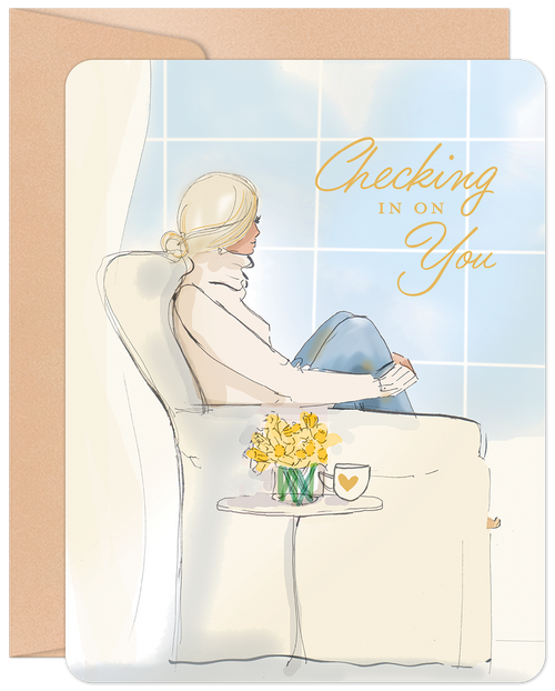 Elegant illustrated greeting card for women, featuring a thoughtful blonde woman looking out a window with a cup of coffee and daffodils. Gold script reads 'Checking in on You'. Perfect for sending support.