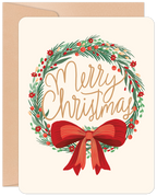 Festive holiday greeting card with a detailed green wreath adorned with red berries and small flowers, centered with 'Merry Christmas' in elegant gold script, and a large red satin bow at the bottom. Includes a kraft paper envelope.
