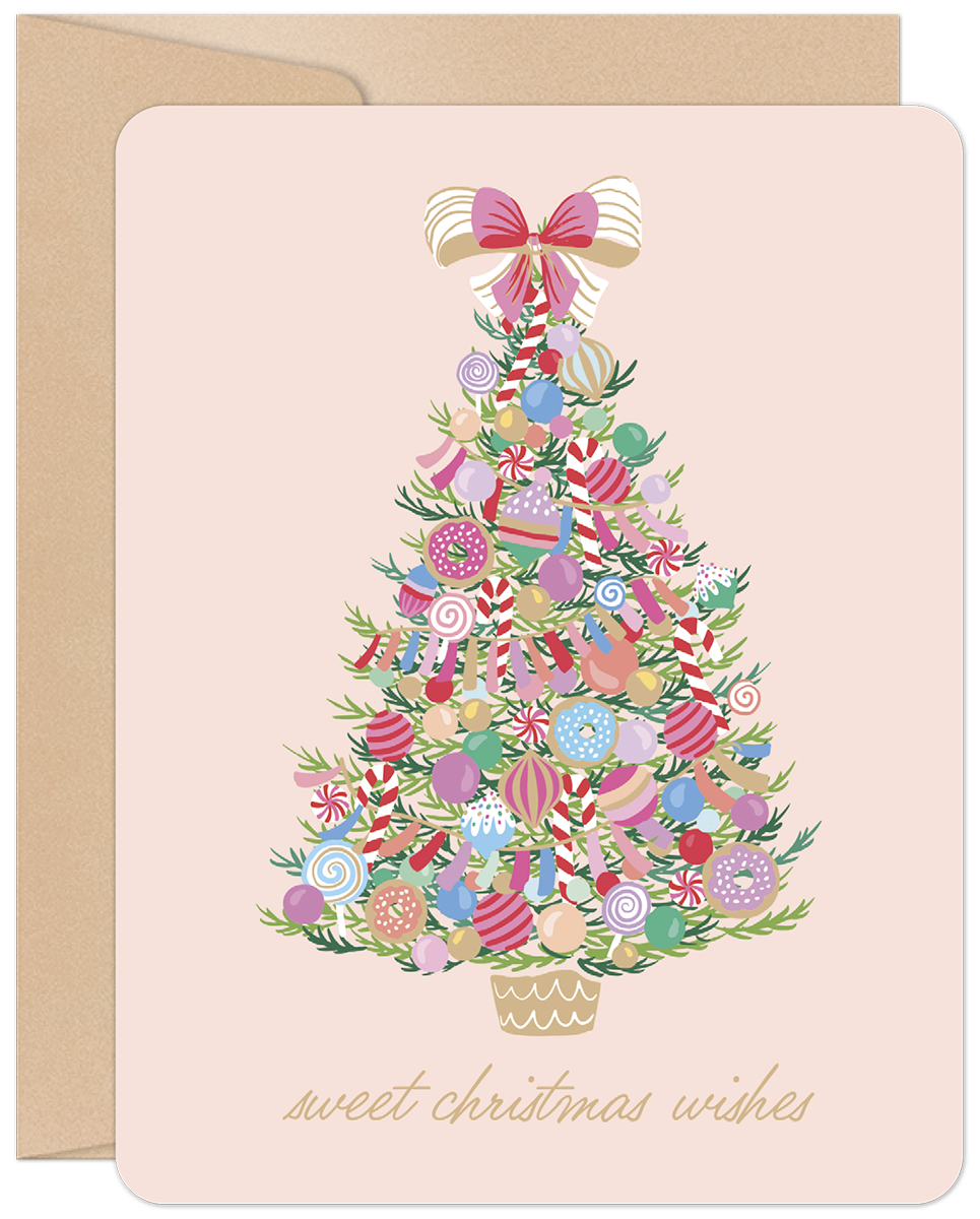 Sweet Christmas Wishes greeting card with a whimsical candy-decorated Christmas tree on a soft pink background and kraft envelope.