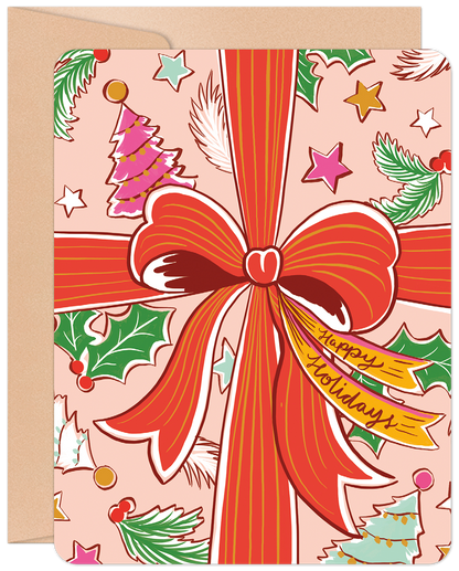 Front of a festive pink Christmas card with a large red bow, 'Happy Holidays' tag, evergreen branches, stars, and colorful Christmas trees.
