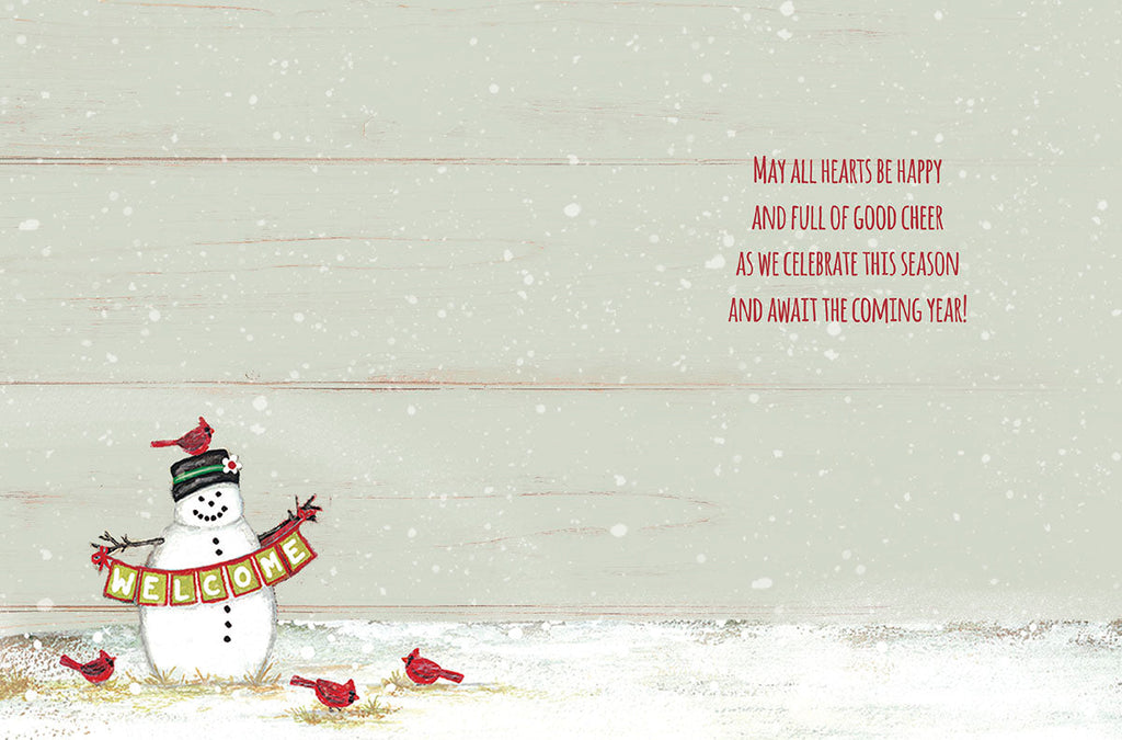 Inside of a lighthearted greeting card showing a cheerful snowman and red cardinals, with the message 'MAY ALL HEARTS BE HAPPY AND FULL OF GOOD CHEER AS WE CELEBRATE THIS SEASON AND AWAIT THE COMING YEAR!' against a rustic snowy background.