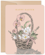Elegant Easter greeting card featuring a watercolor illustration of a spring floral basket with pink orchids, white tulips, and green foliage on a pale pink background, with 'HAPPY EASTER' in gold text.
