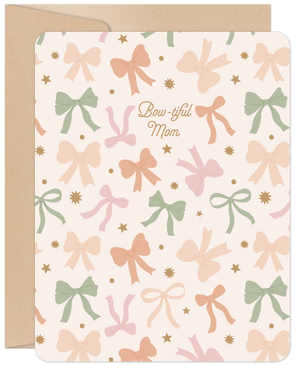 Front of 'Bow-tiful Mom' Mother's Day card with pastel bows, stars, and 'Bow-tiful Mom' text on a light background with kraft envelope.