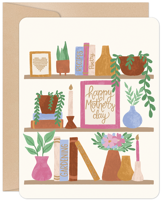 Happy Mother's Day card featuring a charming bookshelf illustration with books, potted plants, and candles on a cream background.