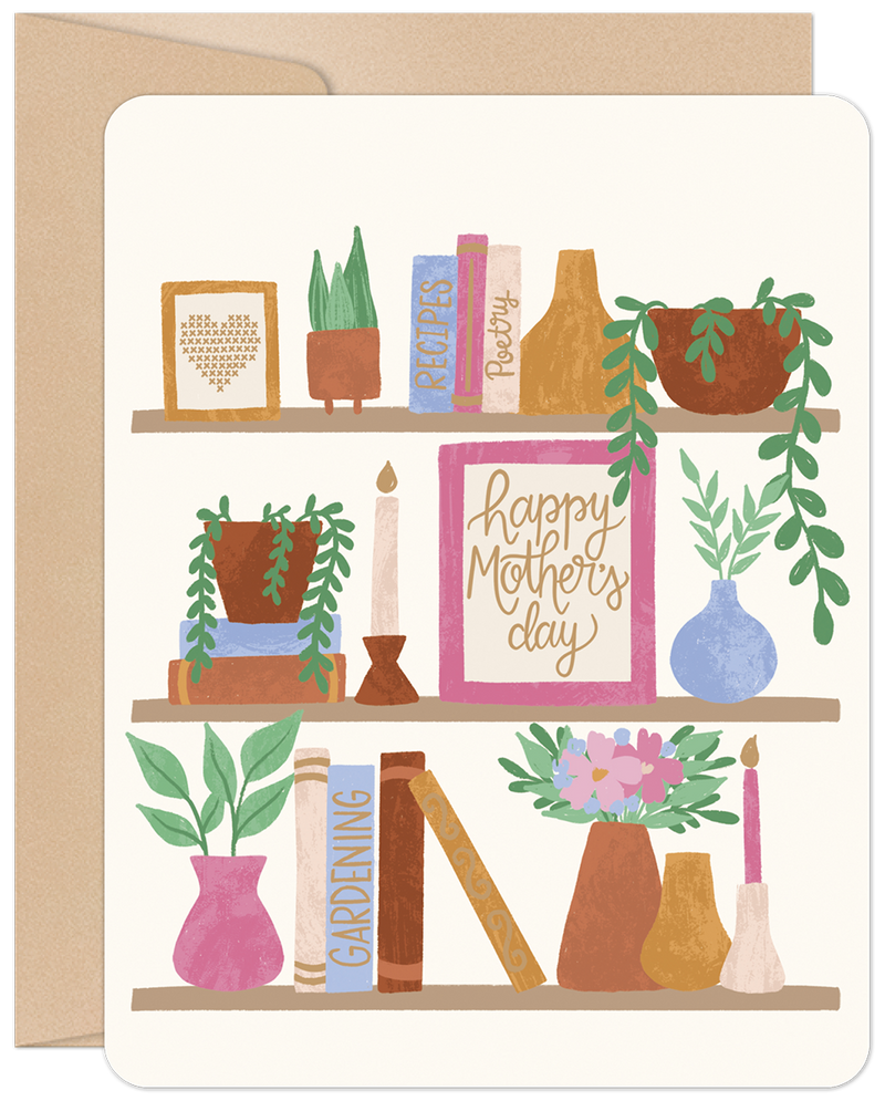 Cozy bookshelf greeting card for Mom, featuring potted plants, decorative books like 'Recipes' and 'Poetry', candles, and a framed 'Happy Mother's Day' message. Perfect for celebrating a special mom.