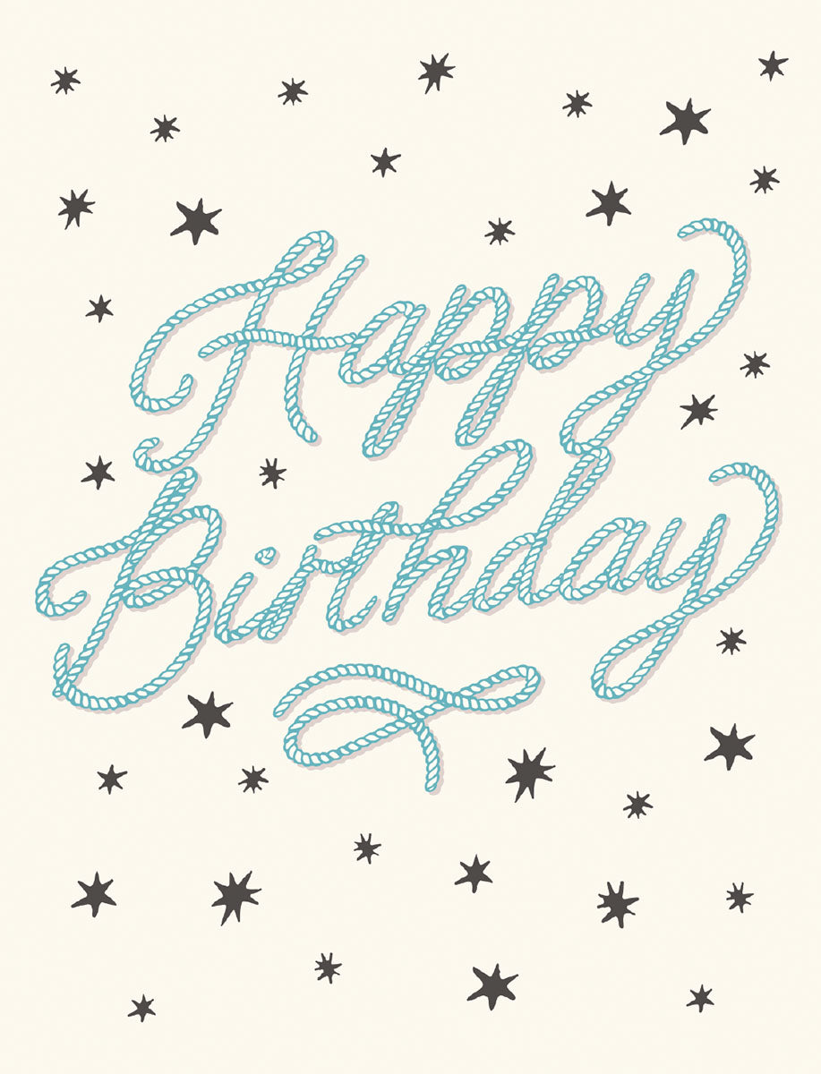 Front of a lighthearted birthday greeting card featuring 'Happy Birthday' in a textured blue rope font, scattered with playful dark grey stars on a cream background.