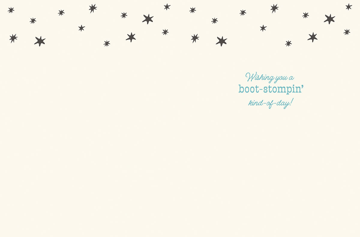 Inside of a lighthearted birthday card, displaying the message 'Wishing you a boot-stompin' kind-of-day!' in blue script, surrounded by dark grey stars on a cream background.