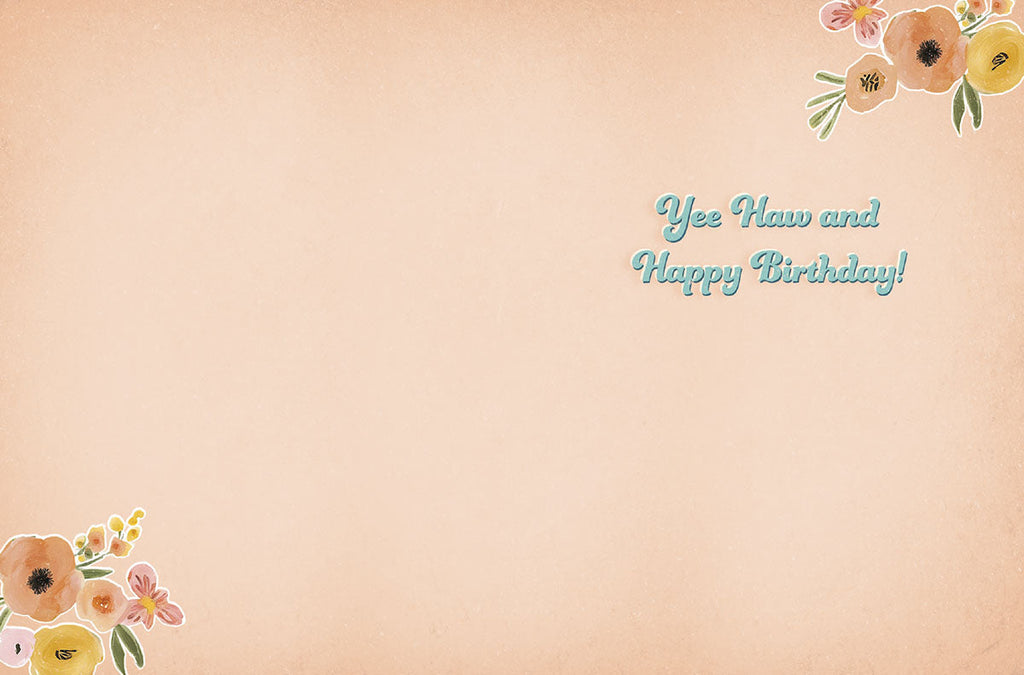 Inside view of a charming cowgirl-themed birthday card, revealing the playful message 'Yee Haw and Happy Birthday!' in matching blue script, with watercolor floral accents in the corners and ample blank space for a personal handwritten note.