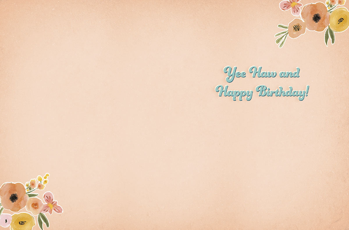 Inside view of a charming cowgirl-themed birthday card, revealing the playful message 'Yee Haw and Happy Birthday!' in matching blue script, with watercolor floral accents in the corners and ample blank space for a personal handwritten note.