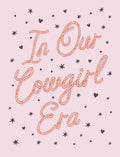 Front of a cute pink greeting card with rope-style text 'In Our Cowgirl Era' surrounded by black stars and hearts, perfect for her friend.