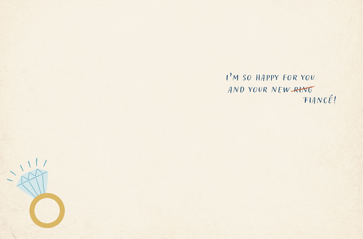 Inside of a congratulatory engagement card with a small diamond ring graphic and the heartfelt message: 'I'M SO HAPPY FOR YOU AND YOUR NEW RING FIANCÉ!'