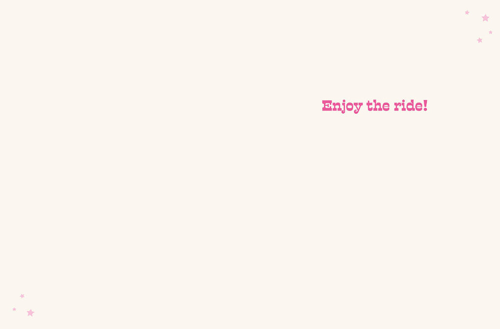 Inside of a minimalist cream-colored greeting card with small pink stars in the corners and the phrase 'Enjoy the ride!' in pink block letters.