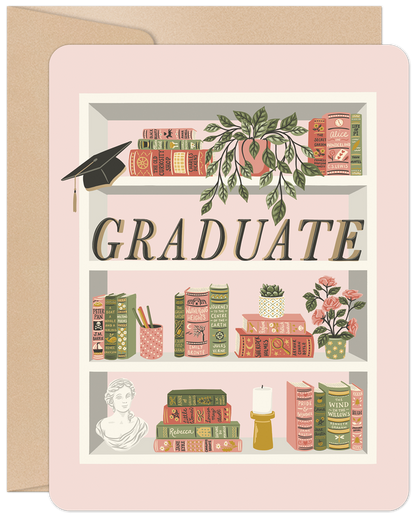 Front of a graduation card with a whimsical bookshelf holding classic books, plants, a bust, and a graduation cap on a pink background.