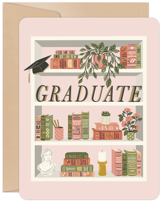 Front of a graduation card with a whimsical bookshelf holding classic books, plants, a bust, and a graduation cap on a pink background.