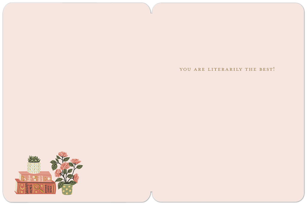 Inside of a graduation greeting card. The pale pink interior displays the message "YOU ARE LITERALLY THE BEST!" in a delicate font, with a small decorative illustration of stacked books and a rose plant in the bottom left corner.