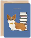Front of a blue graduation greeting card featuring a cute, bespectacled corgi wearing a yellow bow tie, sitting next to a stack of books with the text 'CLEVER BOY!' above.