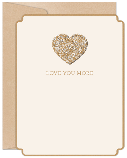 Elegant cream greeting card with a gold foil filigree heart and 'LOVE YOU MORE' text on the front, beside a kraft envelope.