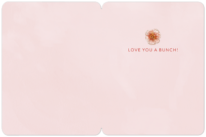 Inside of a light pink greeting card with a small floral design and the message 'LOVE YOU A BUNCH!'.