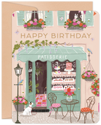 Whimsical patisserie birthday greeting card featuring a charming Parisian street scene with flower boxes, buzzing bees, delightful animals including a dog and cat, and a sweet shop storefront, perfect for celebrating special occasions.