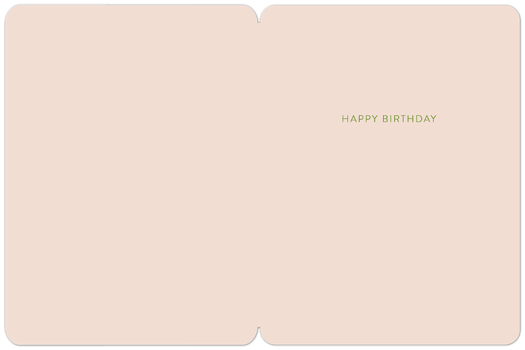Inside of a light pink birthday greeting card with the simple green text 'HAPPY BIRTHDAY' centrally placed, showing ample space for a personalized message.