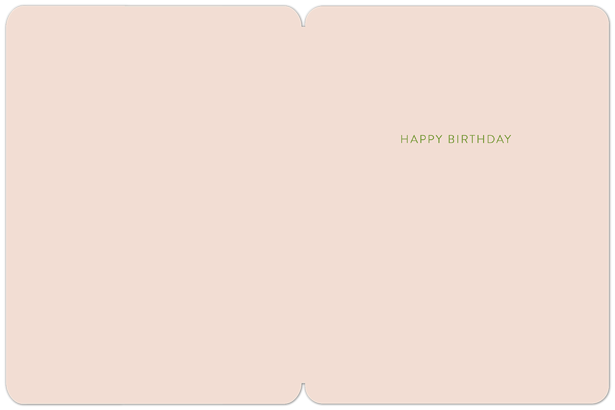Inside of a light pink birthday greeting card with the simple green text 'HAPPY BIRTHDAY' centrally placed, showing ample space for a personalized message.