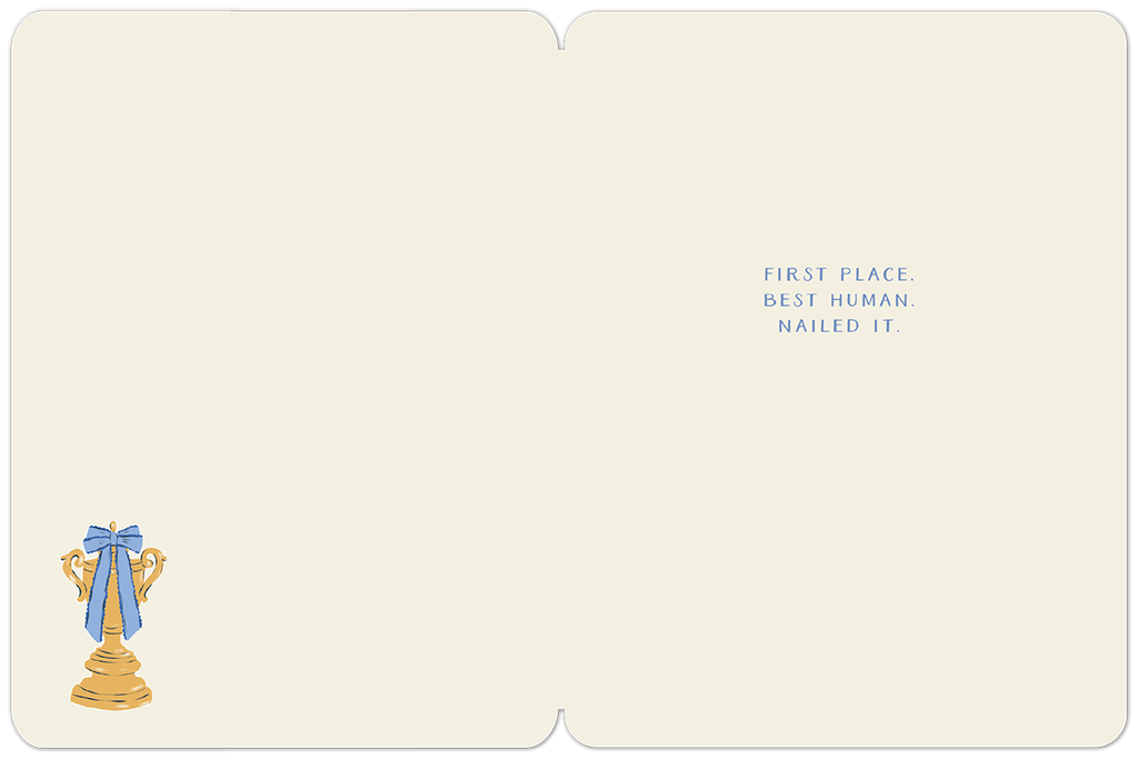 Inside of a congratulatory greeting card with text 'FIRST PLACE. BEST HUMAN. NAILED IT.' on the right, and a small blue-ribboned trophy illustration on the left, perfect for an exceptional pal.