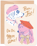 Whimsical greeting card featuring two beret-wearing dogs, a pink poodle and a spotted dalmatian, with 'Bone Jour!' and 'Oui Oui, Mon Amie!' text in gold script, perfect for a special pal.