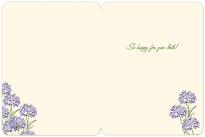 Inside of a wedding card with 'So happy for you both!' in script and delicate purple floral illustrations in the corners.