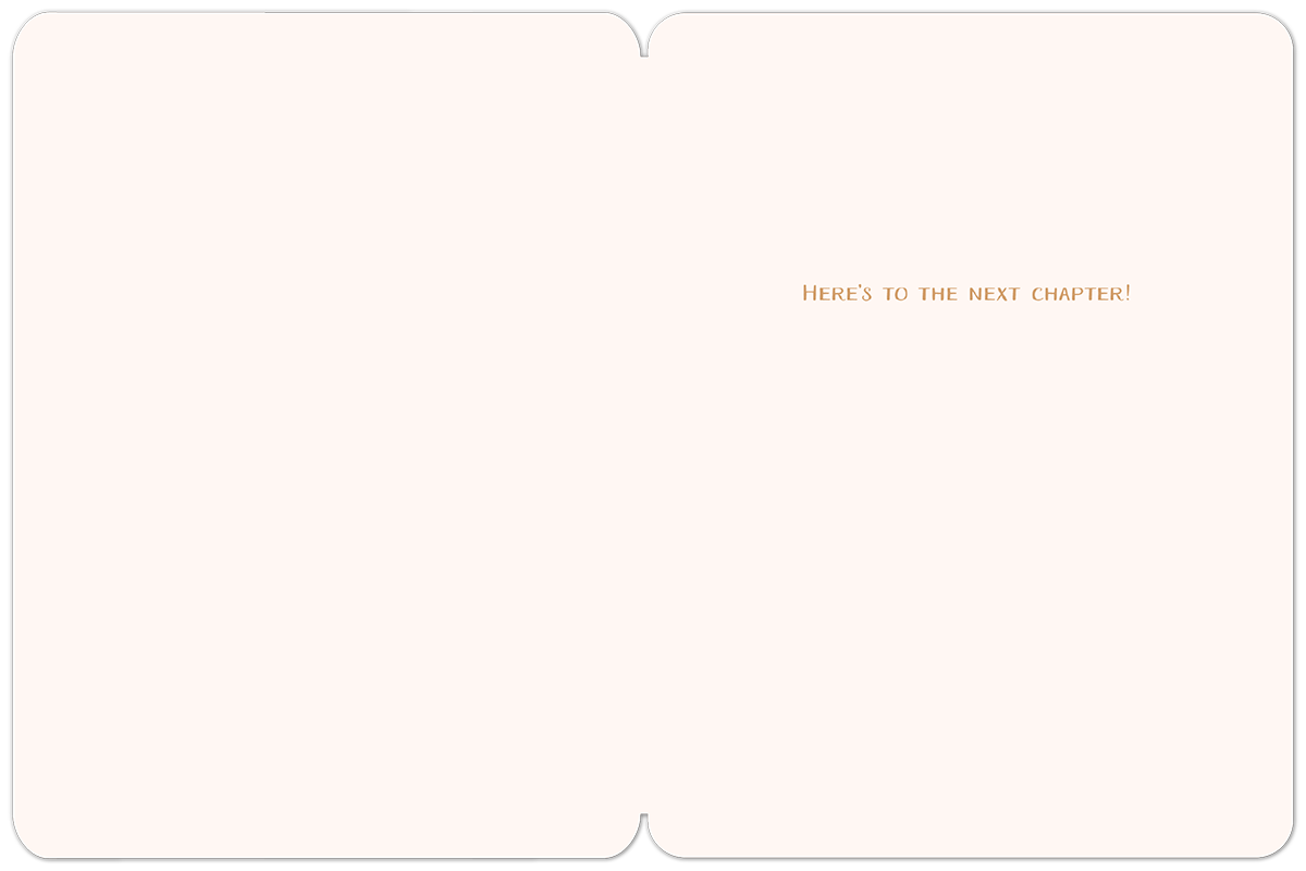 Inside of a blank greeting card with a simple message 'HERE'S TO THE NEXT CHAPTER!' in the upper right corner, ready for a personalized note.