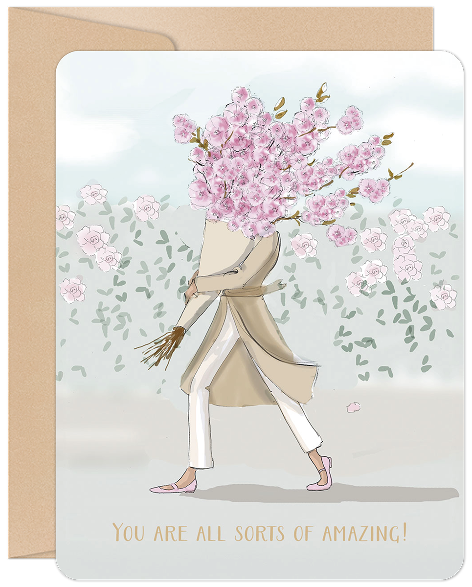A whimsical greeting card featuring a stylish person walking, with their head replaced by a vibrant bouquet of pink cherry blossoms, set against a light blue sky with faint green foliage. The text 'YOU ARE ALL SORTS OF AMAZING!' is written in gold at the bottom. The card has rounded corners and a brown envelope visible behind it.