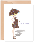 Front of a cute 'Mom to Be' greeting card featuring an illustration of a stylish pregnant woman in a polka dot dress and holding a matching umbrella, on a white background with a kraft envelope.